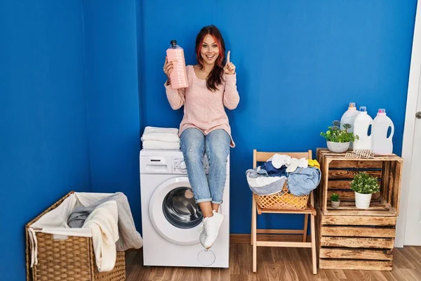 Young Caucasian Woman Sitting Washing Machine Holding Detergent Bottle Smiling — Stockfoto