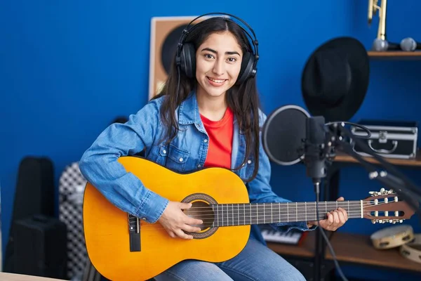 Young Teenager Girl Playing Classic Guitar Music Studio Looking Positive — Fotografia de Stock