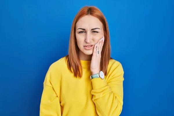 Young Woman Standing Blue Background Touching Mouth Hand Painful Expression — Zdjęcie stockowe