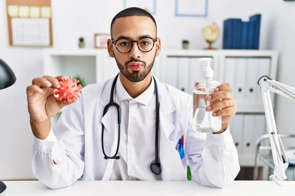 African American Doctor Man Holding Virus Toy Sanitizer Gel Looking — Stockfoto