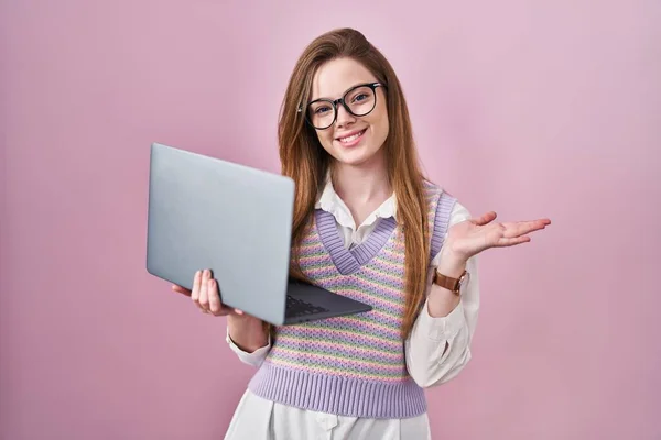 年轻的高加索女人在工作时 用电脑笔记本电脑 手拉手 张开手掌 展示复制的空间 露出兴奋的微笑 — 图库照片