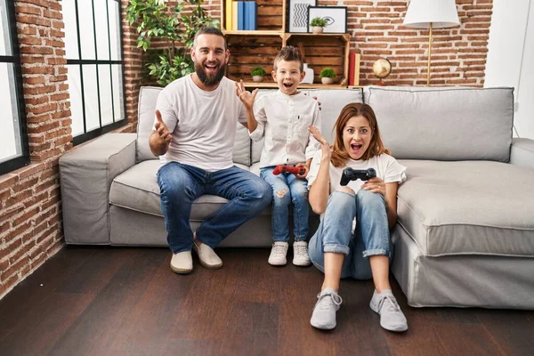 Family Three Playing Video Game Sitting Sofa Celebrating Victory Happy — Stock Photo, Image