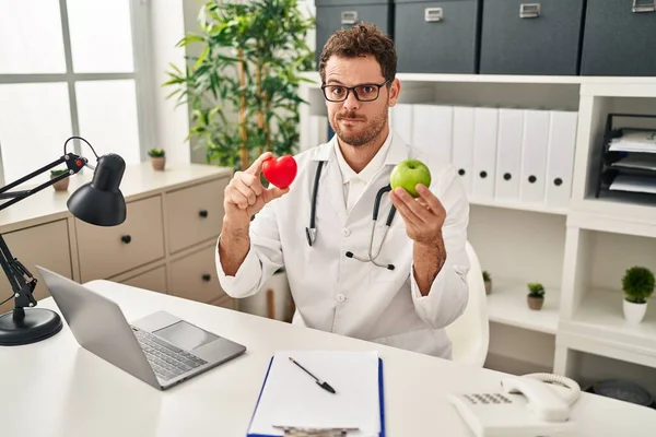 Young Hispanic Man Working Dietitian Clinic Skeptic Nervous Frowning Upset — Foto de Stock