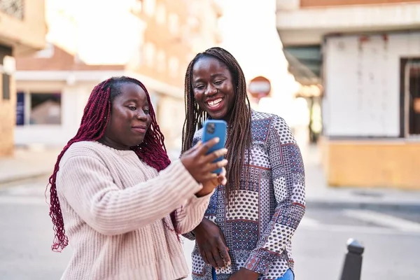 African American Women Friends Smiling Confident Using Smartphone Street — Stockfoto