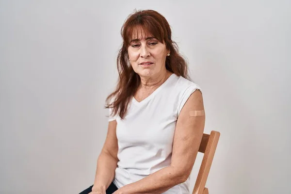 Middle Age Hispanic Woman Getting Vaccine Showing Arm Band Aid — 图库照片
