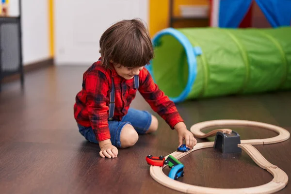 stock image Adorable toddler playing with cars toy sitting on floor at home