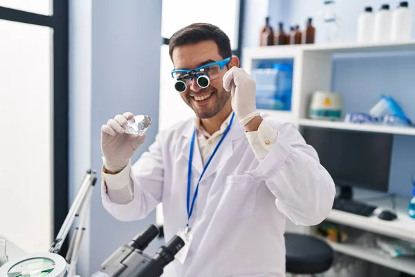 Young Hispanic Man Scientist Looking Diamond Magnifying Glasses Laboratory — Stock Photo, Image
