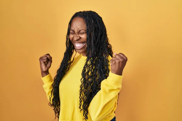 African Woman Standing Yellow Background Very Happy Excited Doing Winner — Zdjęcie stockowe