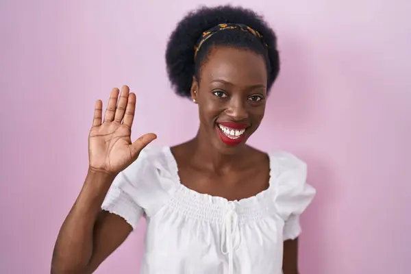African Woman Curly Hair Standing Pink Background Waiving Saying Hello — Fotografia de Stock