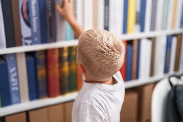Adorable Toddler Holding Book Shelving Classroom — Stock Photo, Image