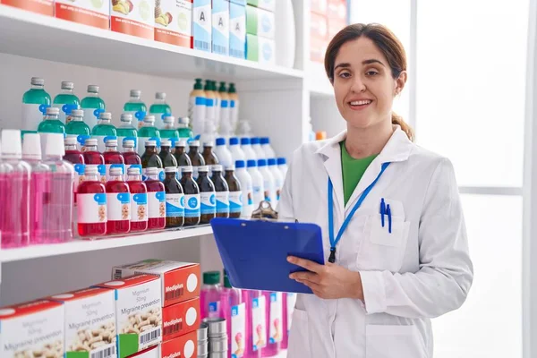 Young Woman Pharmacist Smiling Confident Writing Document Pharmacy — Zdjęcie stockowe