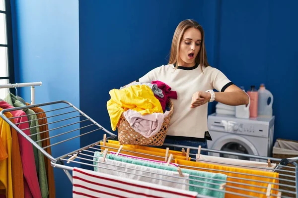 Young Blonde Woman Looking Watch Hanging Clothes Clothesline Laundry Room —  Fotos de Stock