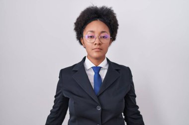 Beautiful african woman with curly hair wearing business jacket and glasses looking sleepy and tired, exhausted for fatigue and hangover, lazy eyes in the morning. 