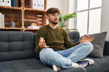 Young arab man patient having yoga exercise at psychology center