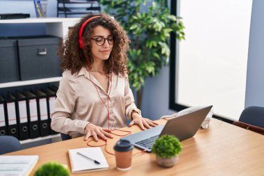 Young hispanic woman business worker doing yoga exercise working at office