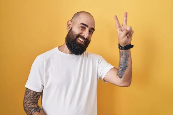 Young Hispanic Man Beard Tattoos Standing Yellow Background Smiling Happy —  Fotos de Stock