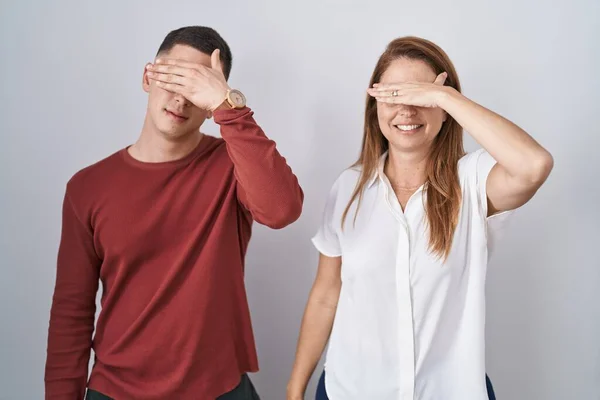 Mother Son Standing Together Isolated Background Covering Eyes Hand Looking — Zdjęcie stockowe