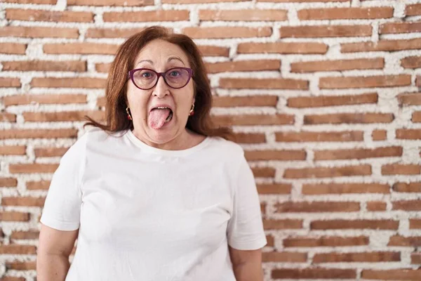 Senior Woman Glasses Standing Bricks Wall Sticking Tongue Out Happy — ストック写真