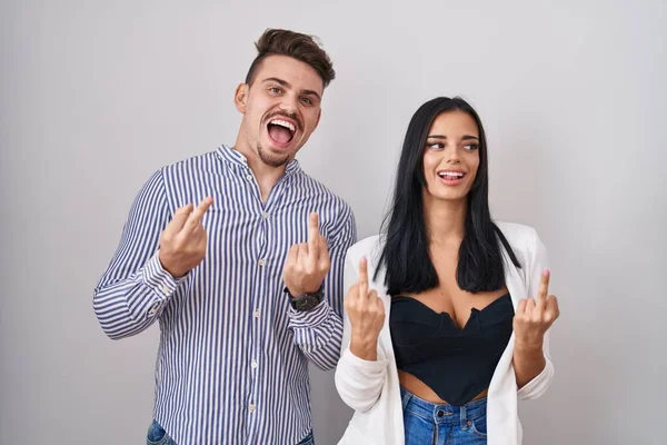 Young Hispanic Couple Standing White Background Showing Middle Finger Doing — Fotografia de Stock