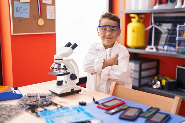 在教室里用显微镜站着 双手交叉地摆出姿势 这是他那可敬的惊慌失措的孩子 — 图库照片