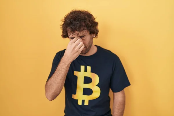 Hispanic Young Man Wearing Bitcoin Shirt Tired Rubbing Nose Eyes — Foto de Stock