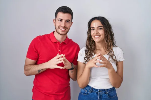Young Hispanic Couple Standing Isolated Background Hands Together Fingers Crossed — Zdjęcie stockowe