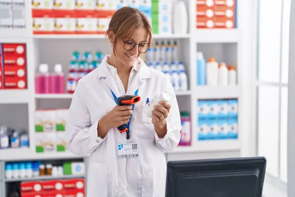Young Blonde Girl Pharmacist Scanning Pills Bottle Pharmacy — Zdjęcie stockowe