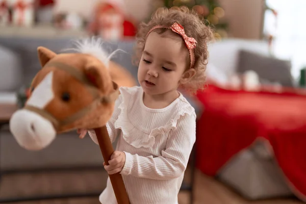 Adorable Caucasian Girl Playing Horse Toy Standing Christmas Tree Home — Stock Photo, Image
