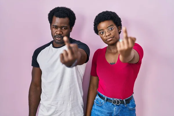 Young African American Couple Standing Pink Background Showing Middle Finger — Foto de Stock