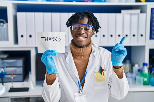 Young African Man Dreadlocks Working Scientist Laboratory Smiling Happy Pointing — Fotografia de Stock