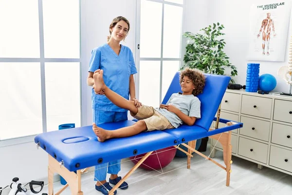 Mother Son Wearing Physiotherapist Uniform Having Rehab Session Stretching Leg — Stok fotoğraf