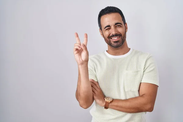 Hispanic Man Beard Standing Isolated Background Smiling Happy Face Winking — Stock fotografie