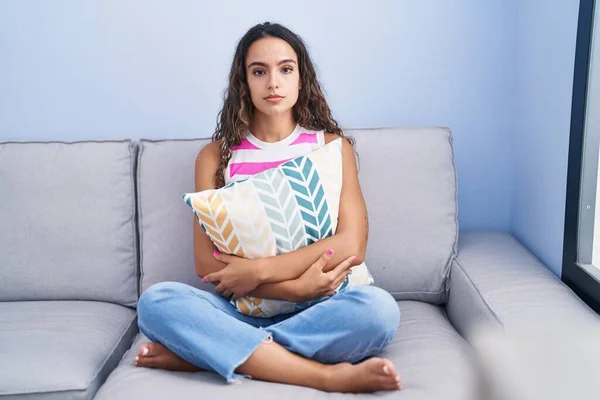 Young Hispanic Woman Sitting Sofa Home Relaxed Serious Expression Face — Stockfoto