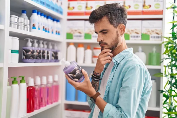 Young Hispanic Man Customer Reading Label Gel Hands Bottle Pharmacy — Stockfoto