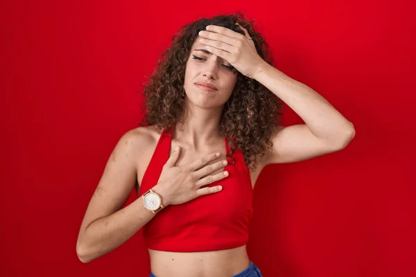 Hispanic Woman Curly Hair Standing Red Background Touching Forehead Illness — Foto de Stock