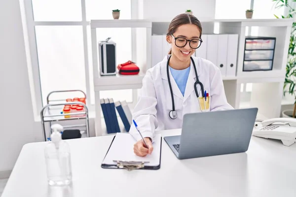 Young Beautiful Hispanic Woman Doctor Using Laptop Writing Medical Report — Stock Photo, Image