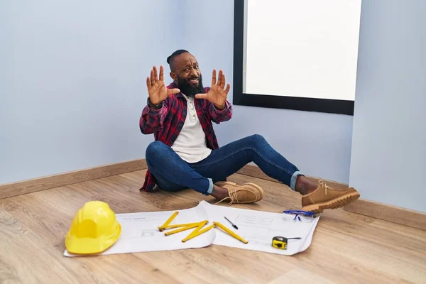African American Man Sitting Floor New Home Looking Blueprints Afraid — Foto de Stock