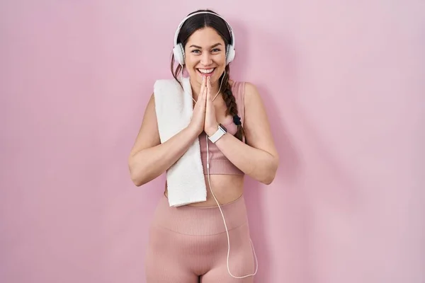Young Brunette Woman Wearing Sportswear Headphones Praying Hands Together Asking — Photo