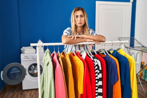 Young Blonde Woman Laundry Room Clean Clothes Depressed Worry Distress — Stockfoto