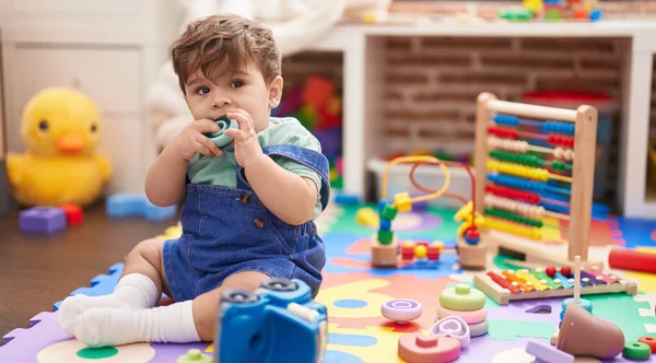 Adorable Hispanic Toddler Sucking Toy Sitting Floor Kindergarten — Stock Photo, Image