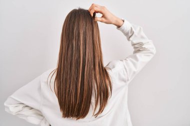 Young caucasian woman standing over isolated background backwards thinking about doubt with hand on head 