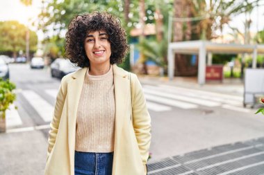 Young middle east woman excutive smiling confident standing at street