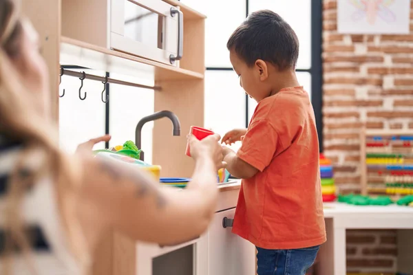 Adorable Hispanic Toddler Playing Play Kitchen Standing Kindergarten — ストック写真