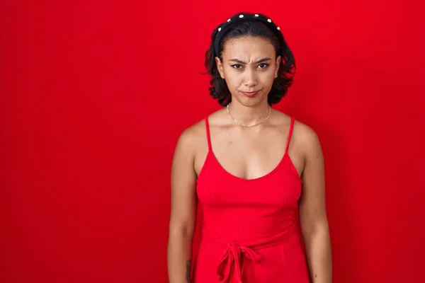 Young Hispanic Woman Standing Red Background Skeptic Nervous Frowning Upset — Stockfoto