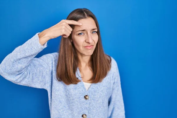 Young Woman Standing Blue Background Pointing Unhappy Pimple Forehead Ugly — Stock Photo, Image