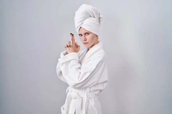 Blonde Caucasian Woman Wearing Bathrobe Holding Symbolic Gun Hand Gesture —  Fotos de Stock