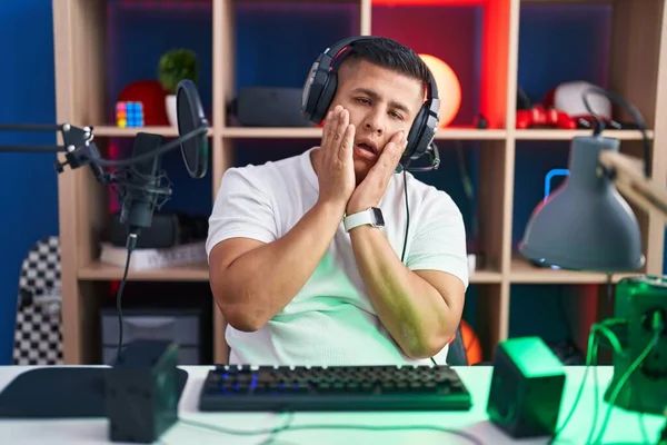 Young Hispanic Man Playing Video Games Tired Hands Covering Face — Foto de Stock