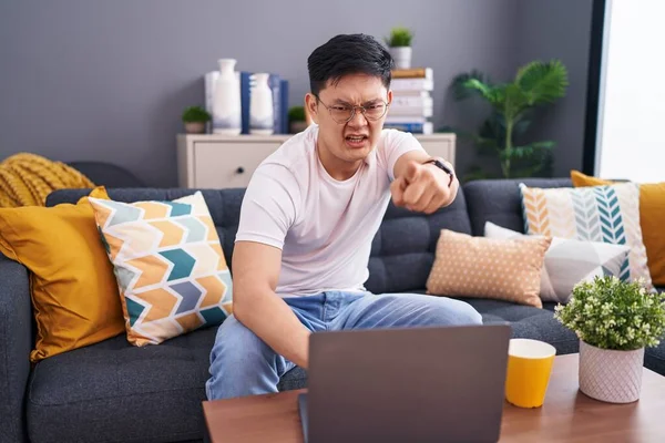 Young Asian Man Using Laptop Home Sitting Sofa Pointing Displeased — 图库照片