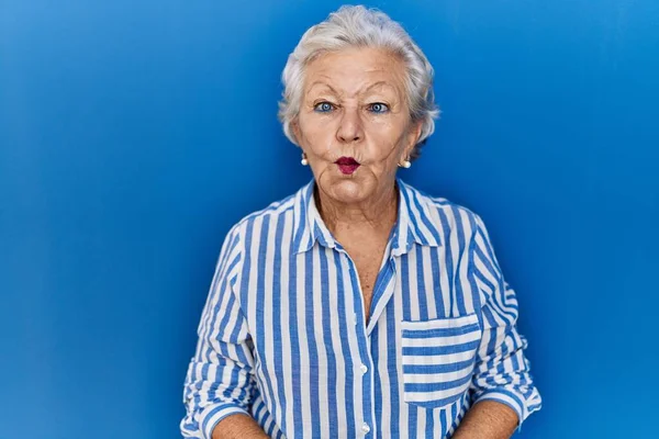 Starší Žena Šedými Vlasy Stojící Nad Modrým Pozadím Dělá Rybí — Stock fotografie