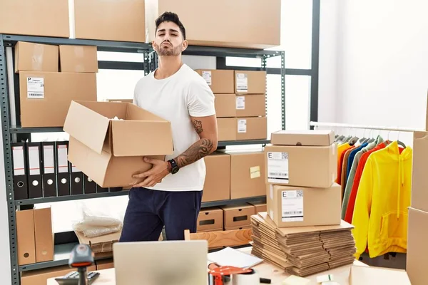 Young Hispanic Man Working Small Business Ecommerce Looking Camera Blowing — Foto Stock